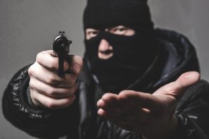 Robber with a gun in a mask
